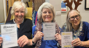 Residents Barbara, Margaret and Sandy receiving their Makaton Certificates during the Christmas Choir Show.